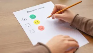 Female ticking on happy smiley face as excellent service